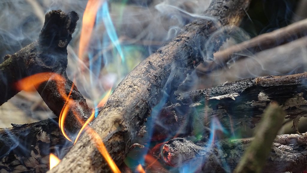 Magical colourful flames in the explorer's campfire.