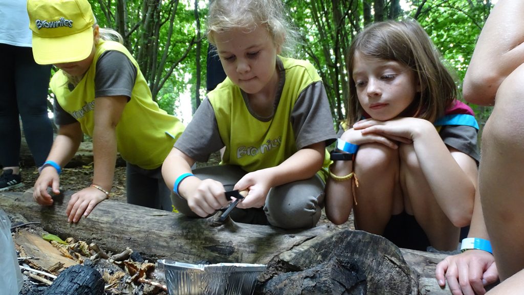 Brownies using a flint and steel to light a fire.
