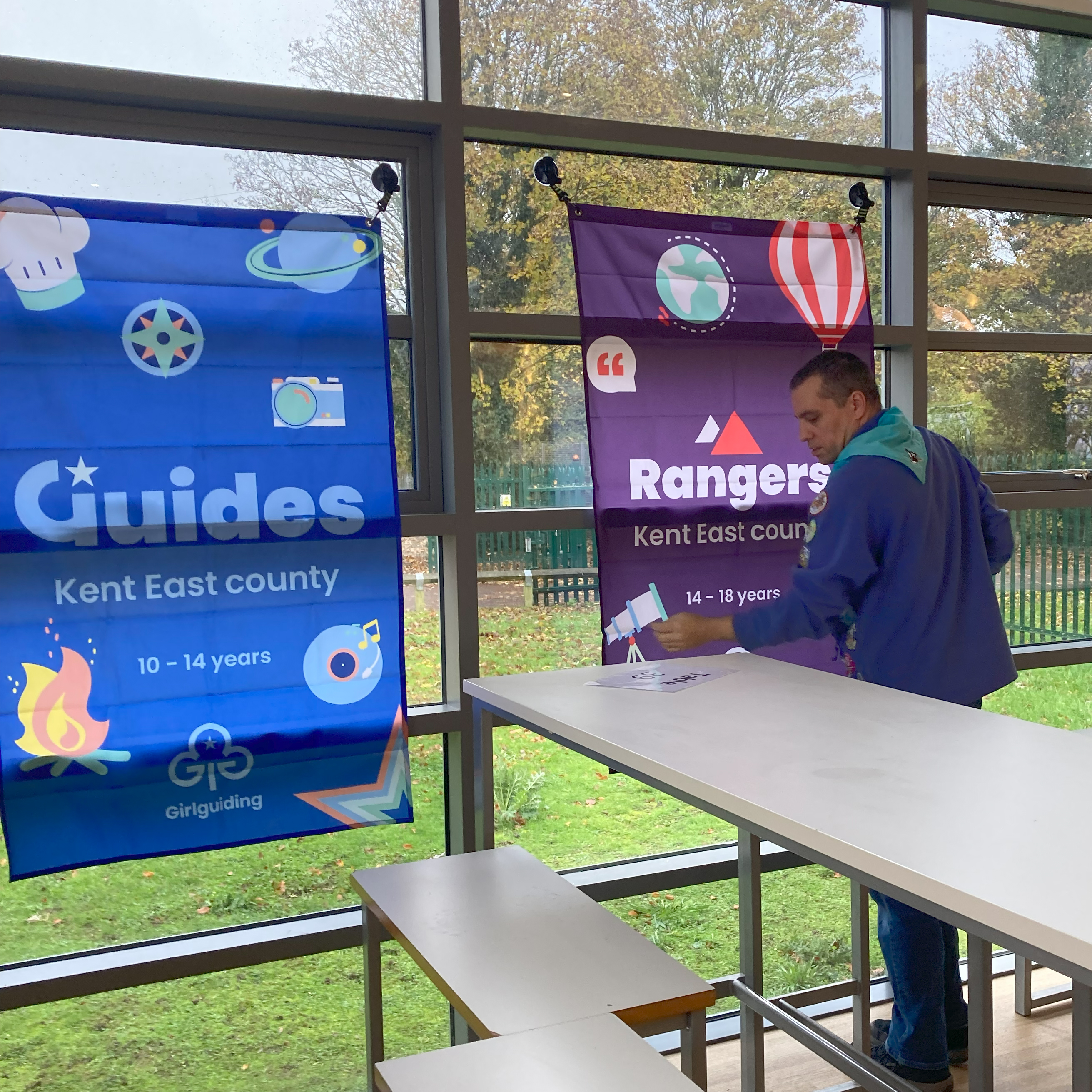 Girlguiding branding. Putting up banners for Guides and Rangers.